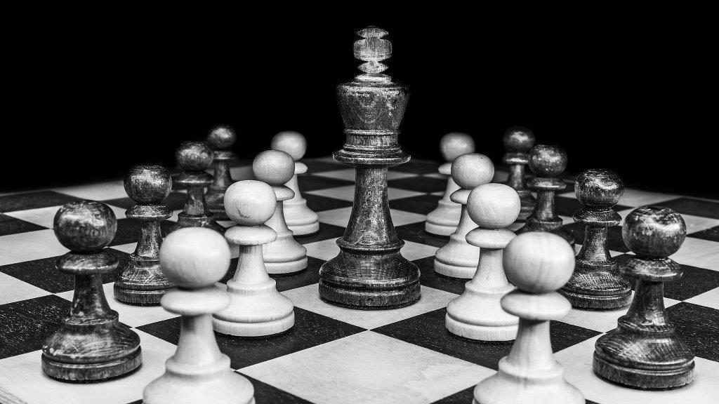 black an white chess board with pawns and king